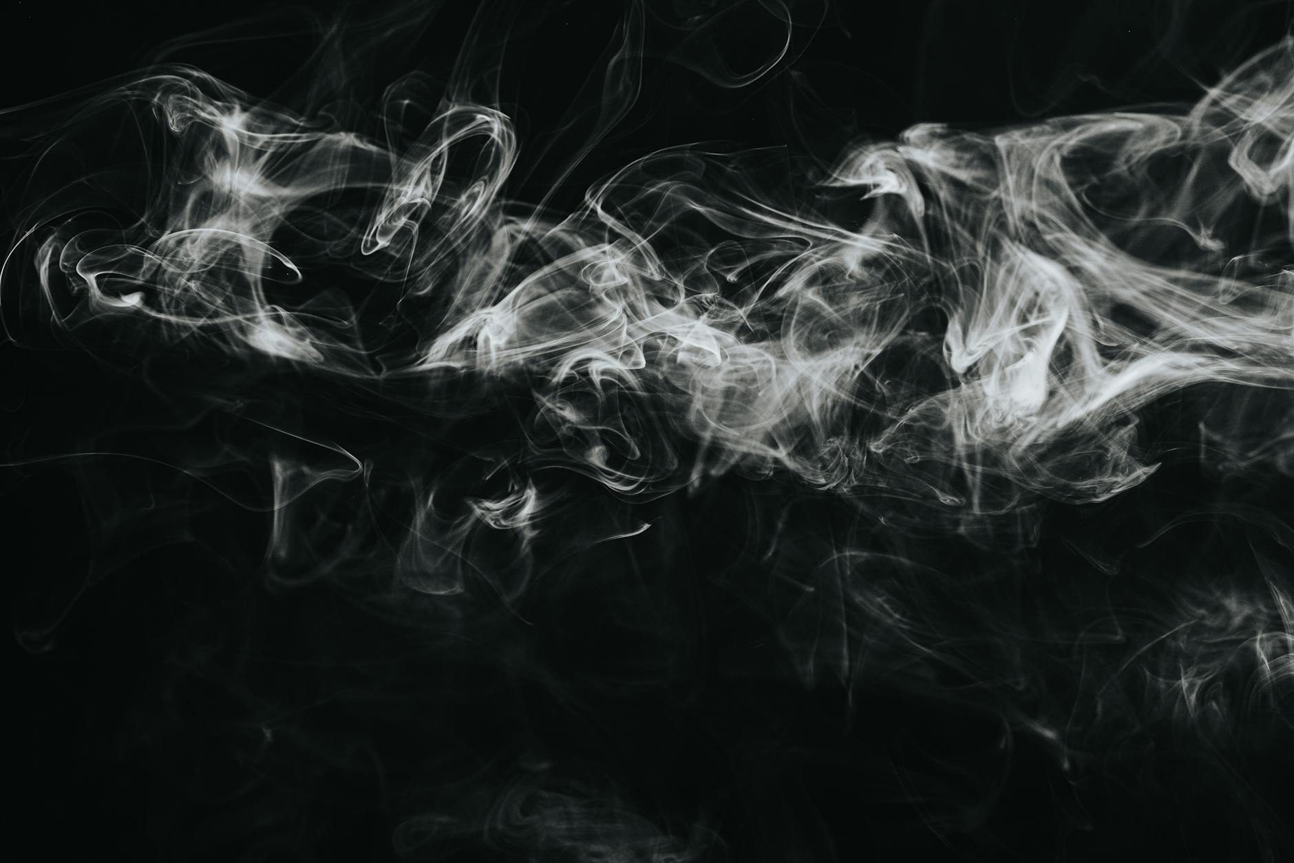 white smoke against black background